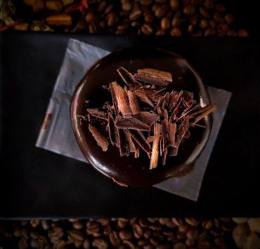 brown and white coffee beans on black paper
