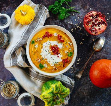 soup with sliced lemon on white ceramic bowl