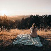 person sitting in front of trees