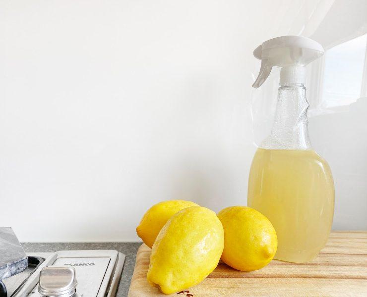 yellow lemon fruit beside clear glass bottle
