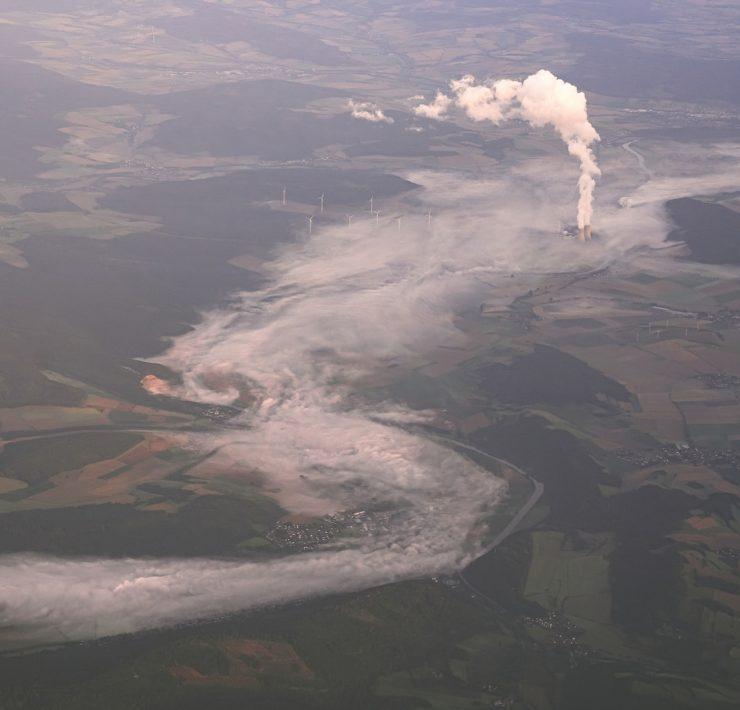an aerial view of a river running through a field