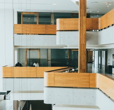 brown wooden table near white wall