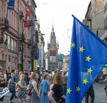 people walking on road between buildings