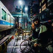 man riding bike near gray running train