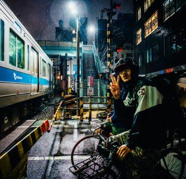 man riding bike near gray running train