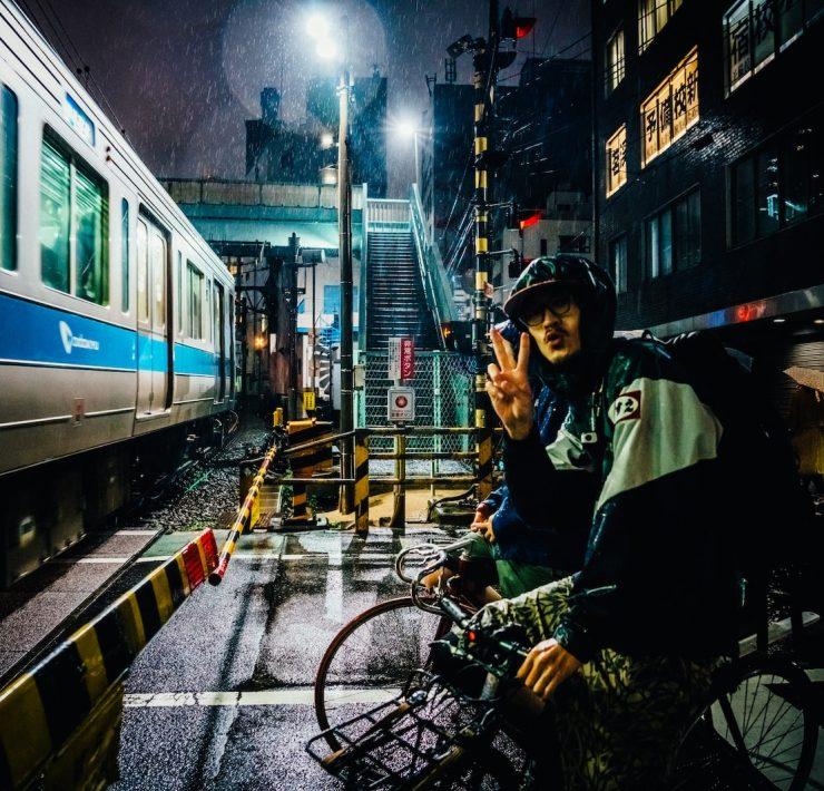 man riding bike near gray running train