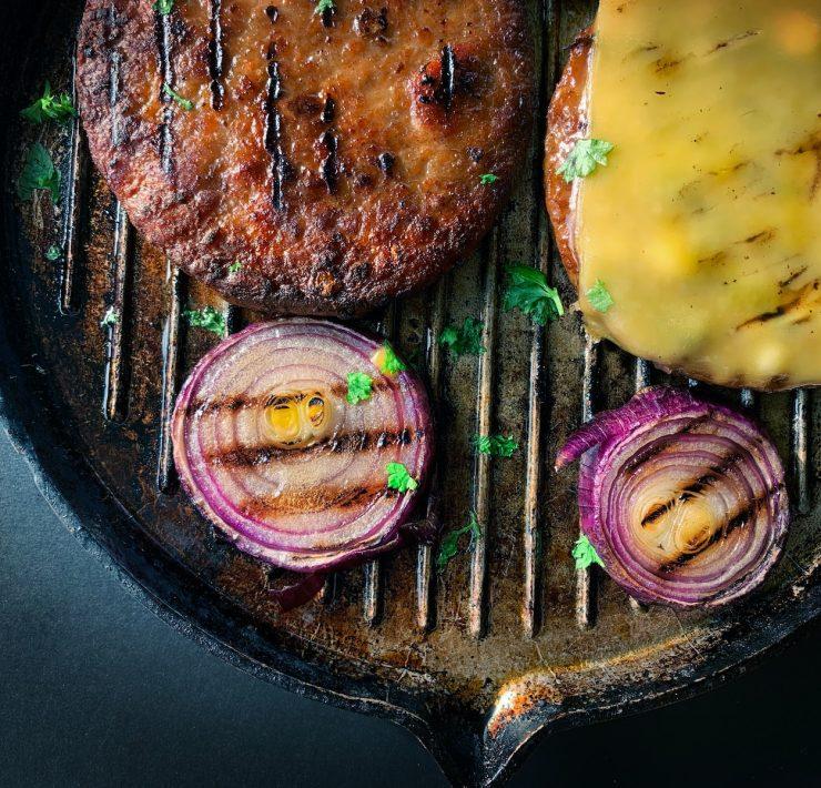 fried meat with sliced cucumber on black plate