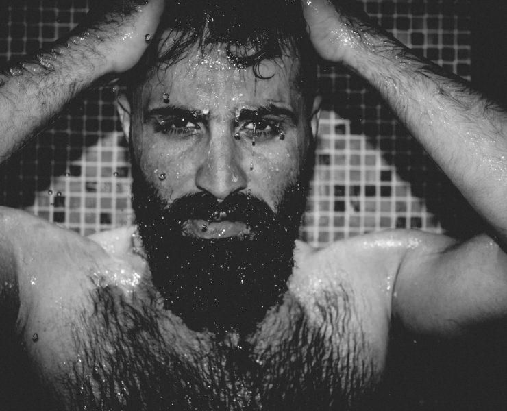 topless man with black face paint