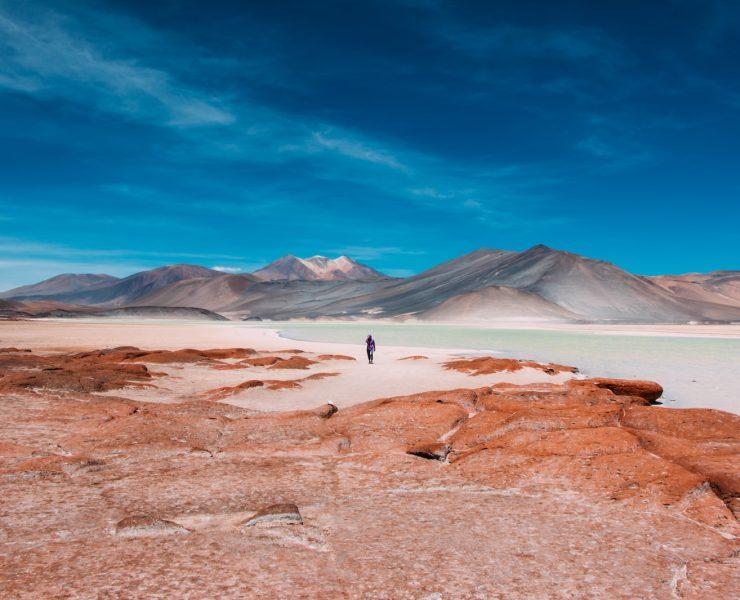 person walking in distance of mountain