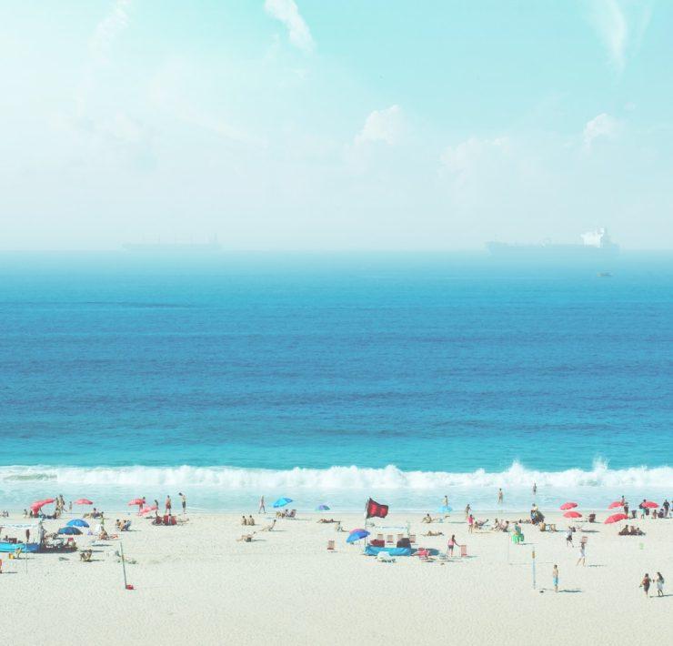 group of people on white sand beach