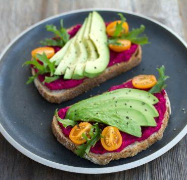 two sliced breads with avocado on top
