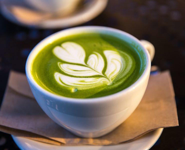 white ceramic teacup filled of matcha tea