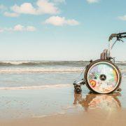 a wheel chair sitting on top of a sandy beach