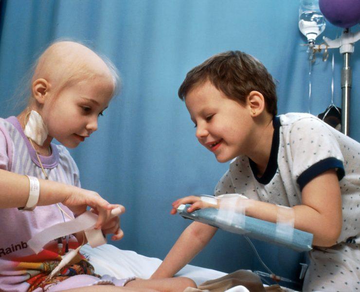 girl and boy playing on bed