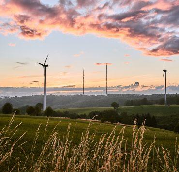green grass field under cloudy sky during daytime