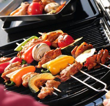 a person is grilling food on a grill