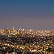 city skyline under blue sky during night time
