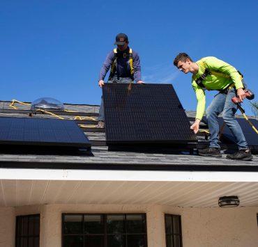 men on top of a roof