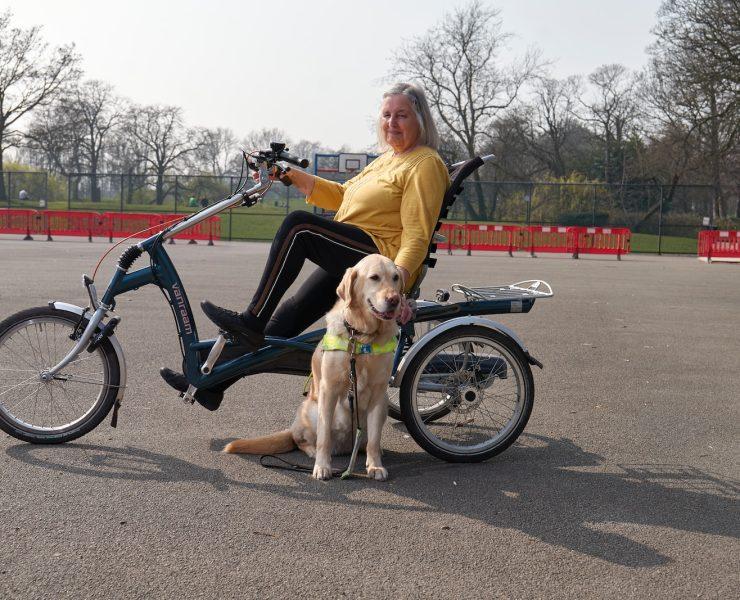 a person on a bicycle with a dog on a leash