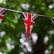 a british flag bunting on a tree line