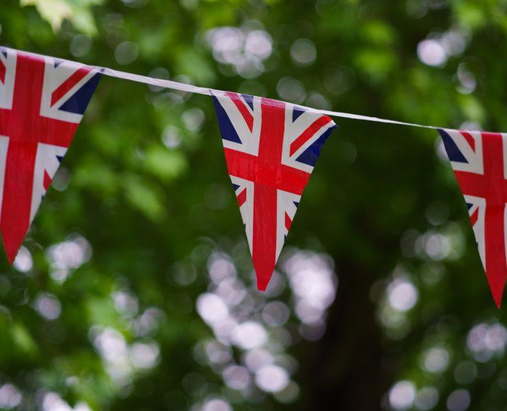 a british flag bunting on a tree line