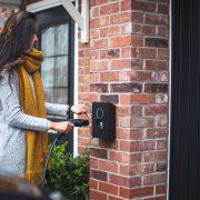 a woman is opening the door of her house