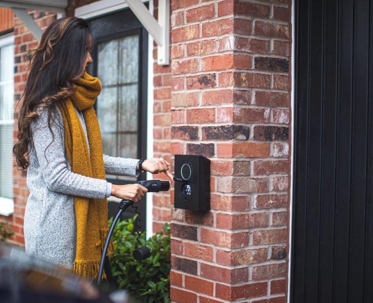 a woman is opening the door of her house