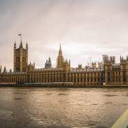brown concrete building near body of water during daytime