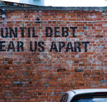 until debt tear us apart brick wall vandal