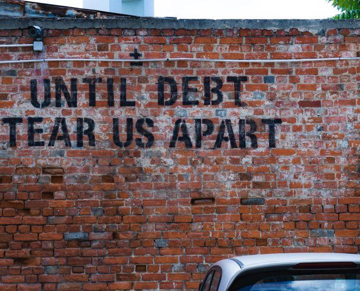 until debt tear us apart brick wall vandal