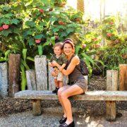 woman in black tank top sitting on brown wooden bench