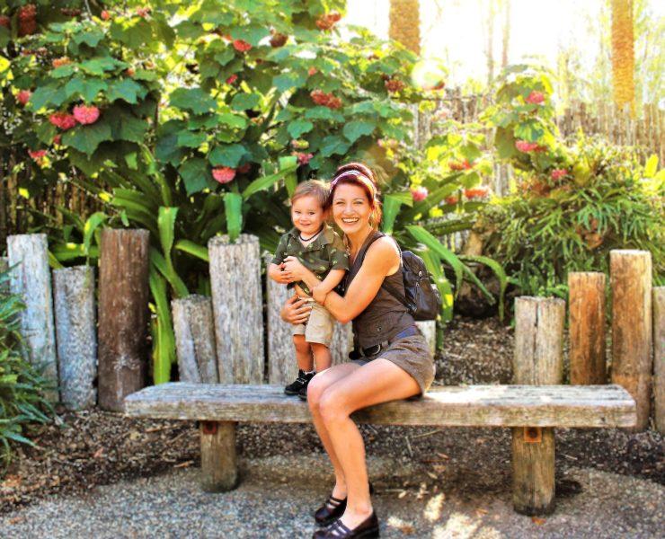 woman in black tank top sitting on brown wooden bench