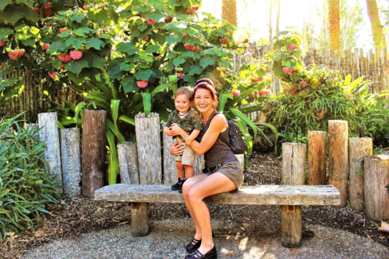 woman in black tank top sitting on brown wooden bench