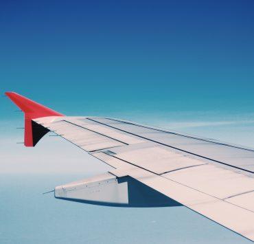 white and red airplane wing