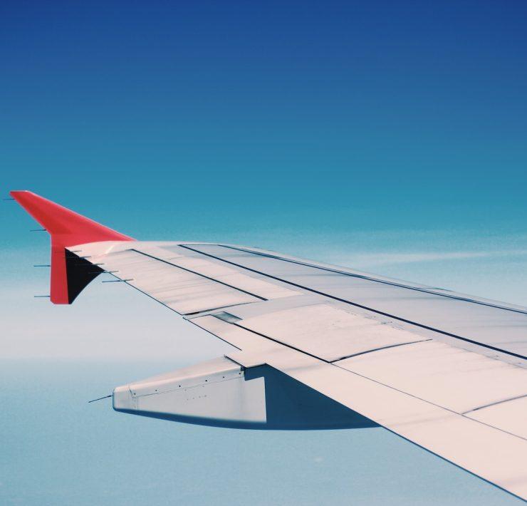 white and red airplane wing