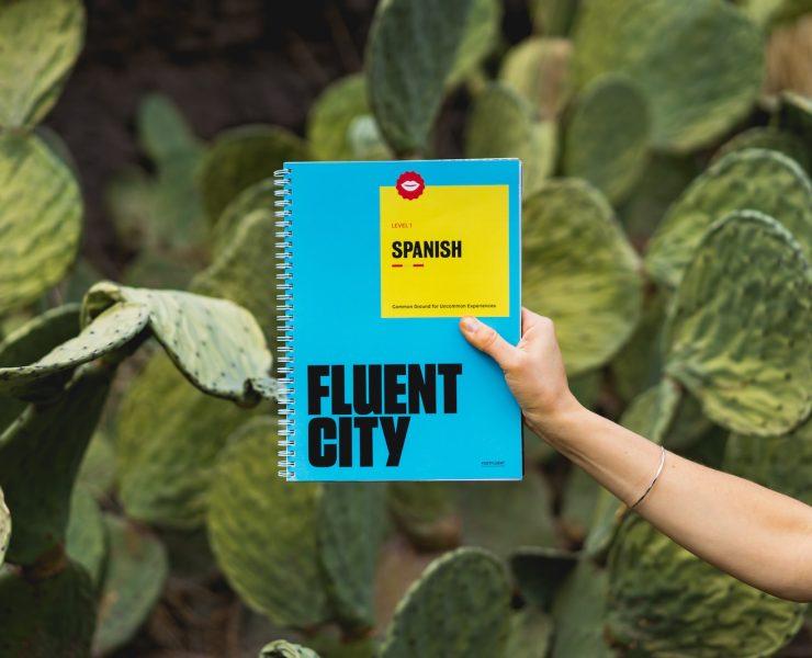 person holding Fluent City book