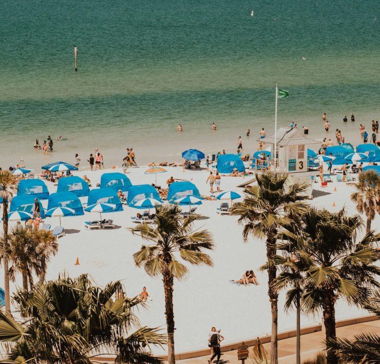 blue and white tents in beach with people