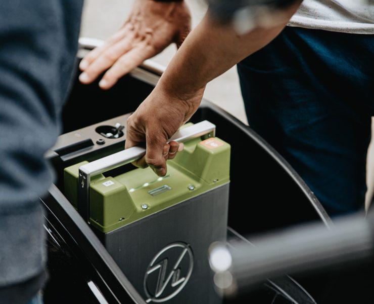 person holding black and green electronic device