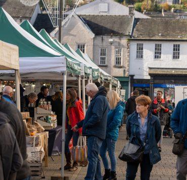 a group of people at an outdoor market