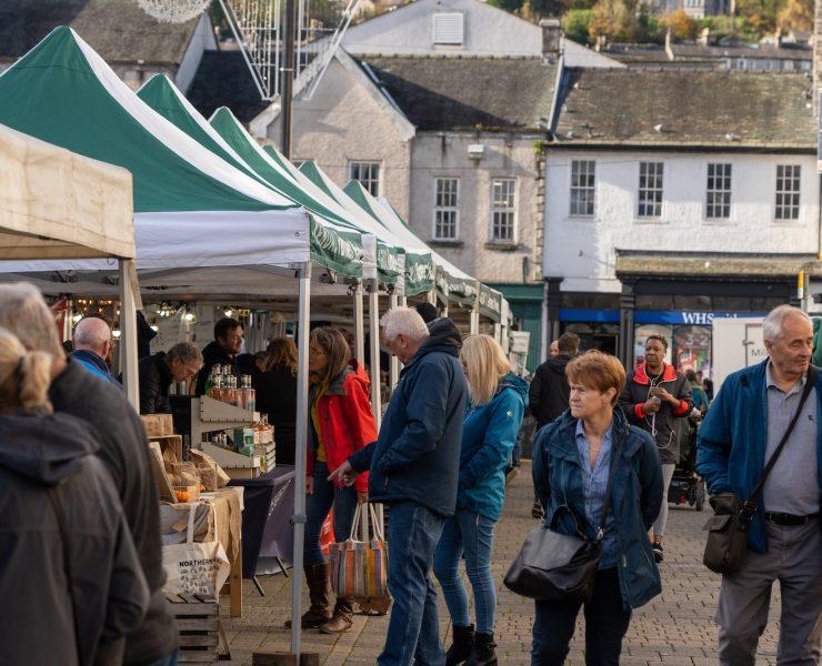 a group of people at an outdoor market