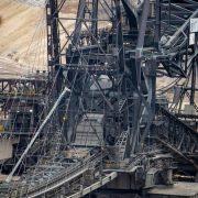 there is a large crane that is in the dirt