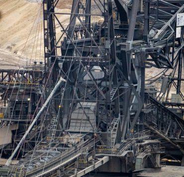 there is a large crane that is in the dirt