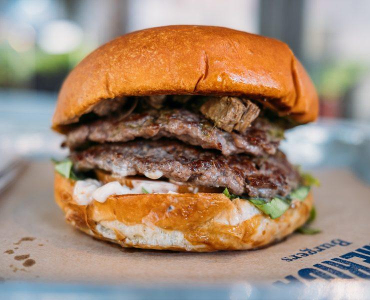 a close up of a hamburger on a tray