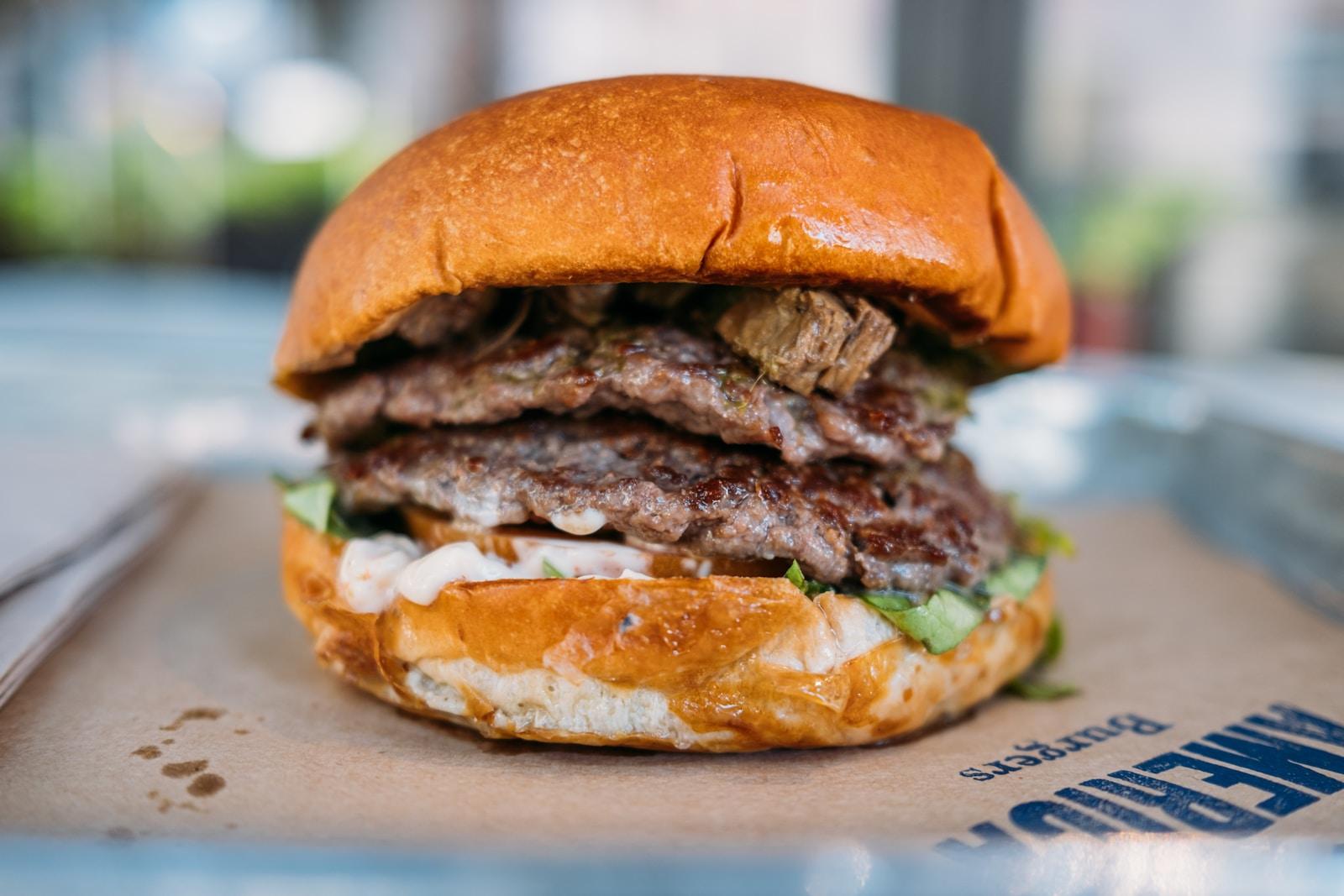 a close up of a hamburger on a tray