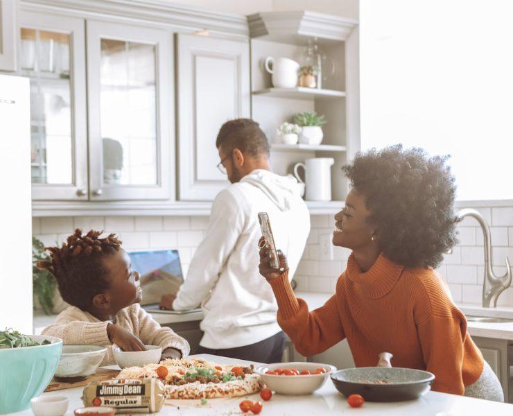 man in white dress shirt sitting beside woman in orange long sleeve shirt
