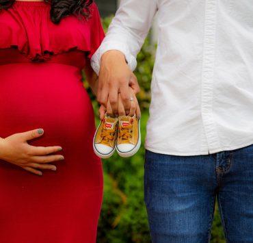 couple holding pair of brown and white low-top sneakers