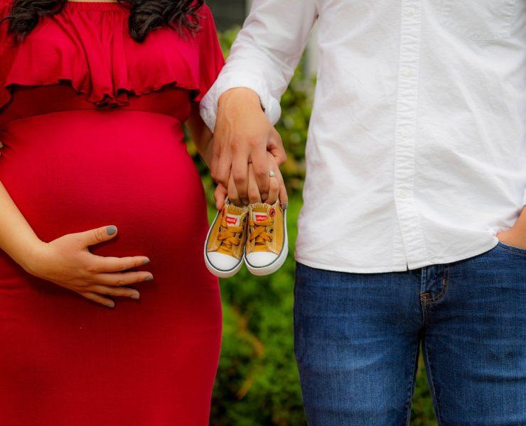 couple holding pair of brown and white low-top sneakers