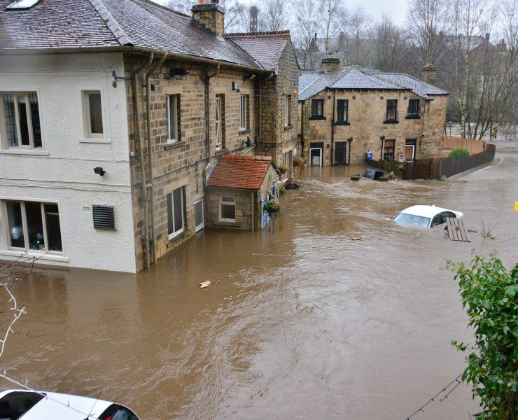 brown and white concrete house beside river during daytime
