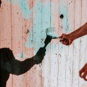 person painting wall