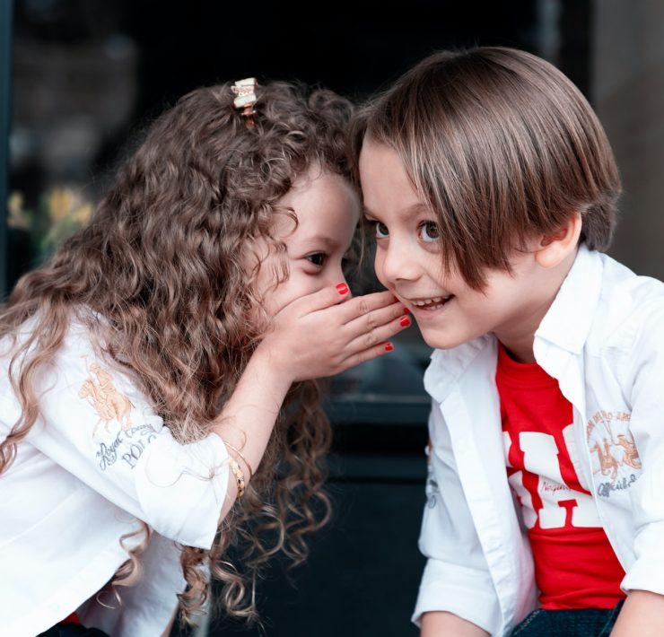 woman in white long sleeve shirt kissing girl in white long sleeve shirt